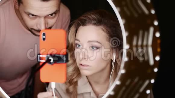 盖伊和年轻女子美容博客预设智能手机前的铃声视频的预览图