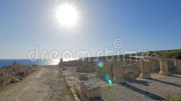 在阳光明媚的夏日古希腊遗迹在海边阳光在镜头前闪耀视频的预览图
