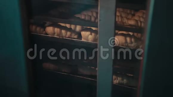 里面有洞的牛角面包放在架子上的托盘上在烤箱里烤视频的预览图