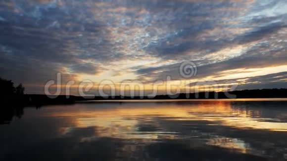 壮观的云彩和日落在宽阔的湖泊上的全景景观视频的预览图