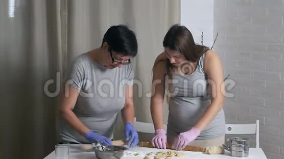 戴着亮手套的女人把面团擀在桌子上自制食物馄饨饺子视频的预览图