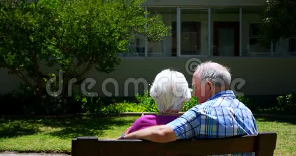 活跃的高加索老夫妇在养老院花园观看相册的后景视频的预览图