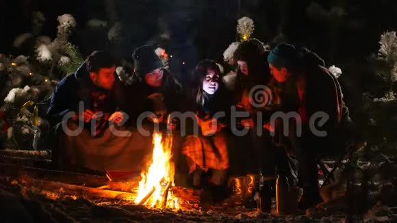 冬林之友群坐在篝火旁裹着毯子听着故事害怕起来视频的预览图