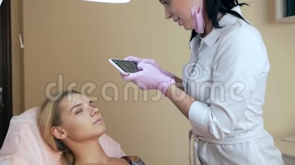 美容师在手术结束后在电话上拍了一张脸部照片视频的预览图
