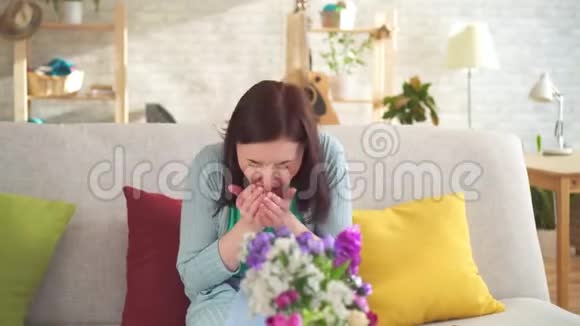 坐在现代公寓里过敏的年轻女子打喷嚏戴着呼吸器视频的预览图