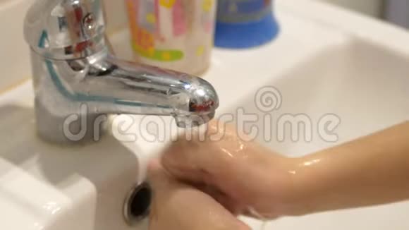 一个孩子在浴室里用冠状病毒或病毒的肥皂洗手视频的预览图
