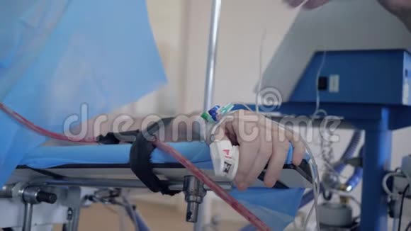 护士将点滴滴入导管躺在手术室手臂上的心率监测仪视频的预览图