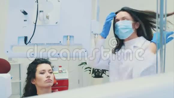 牙医和病人年轻漂亮的牙医在牙医办公室修理一位漂亮年轻女子的牙齿牙医视频的预览图