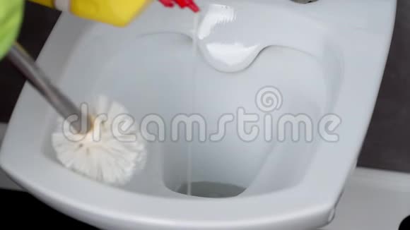 使用刷子和洗涤剂清洗马桶的绿色手套中的女性手房屋清洁和家庭的概念视频的预览图
