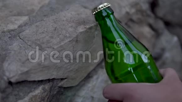 男人不打开一瓶碳酸饮料撞到路边金属盖子玻璃瓶视频的预览图