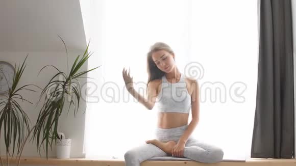 漂亮的女运动员穿着训练服在瑜伽馆做健身运动视频的预览图