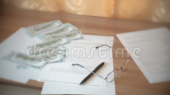 眼镜纸钱文件和桌子上的一支笔视频的预览图