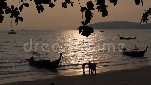 日落时海边的人和船视频的预览图
