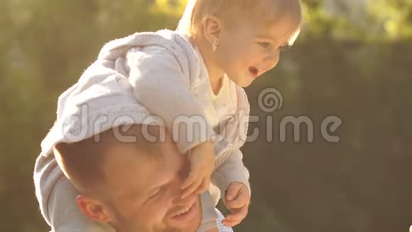 快乐的年轻家庭一起在外面度过时光公园里一个美丽幸福家庭的近景视频的预览图