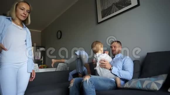 一个有两个孩子的小家庭的周末家长和孩子在家放松幸福家庭视频的预览图
