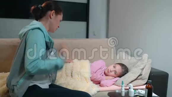 女人放一个体温计生病的小女儿母亲测量女儿身体温度视频的预览图
