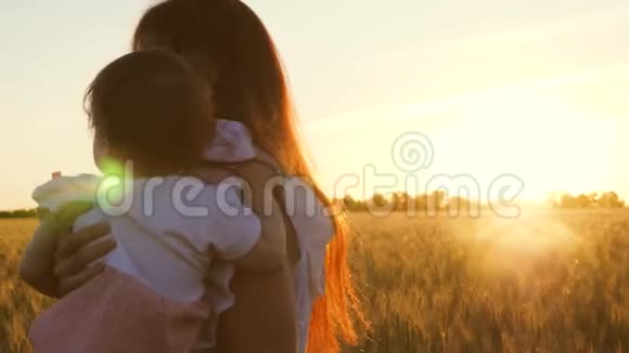 母婴出行幸福的家庭观念年轻的母亲和她的小女儿在田野里跳舞和欢笑视频的预览图