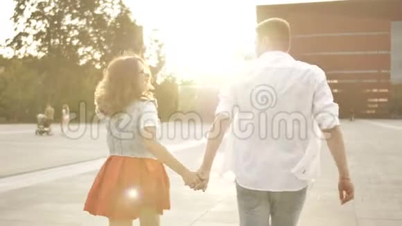 年轻夫妇牵着手女人牵着男朋友走上街头视频的预览图