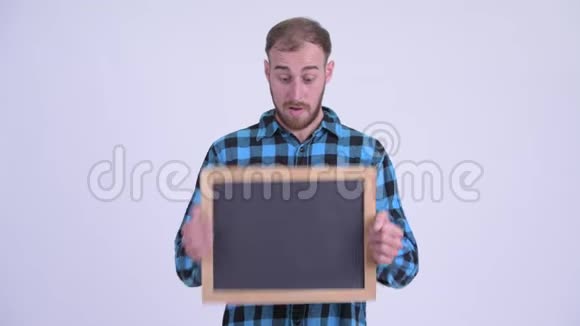 快乐的留胡子的时髦男人拿着黑板看上去很惊讶视频的预览图