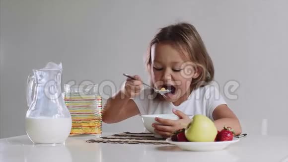 饥饿的小女孩正在用牛奶快速地吃玉米片视频的预览图