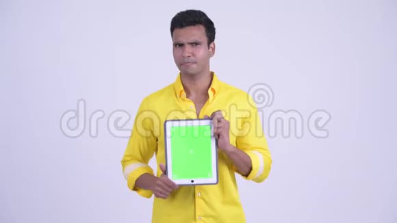 快乐的年轻印度商人一边讲一边展示数字平板电脑视频的预览图
