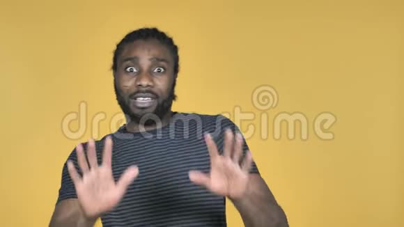 黄色背景下的非洲男子困惑与恐惧问题视频的预览图