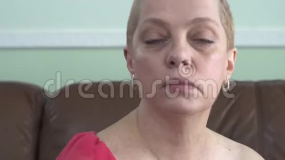 成熟的女人在看镜头时脸上涂面霜最佳皮肤护理视频的预览图