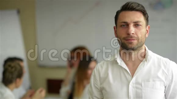 一个英俊的年轻商人站在办公室的肖像聪明的白种人年轻男性设计师和他的同事视频的预览图