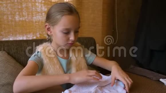 小女孩坐在咖啡馆的桌子旁用湿毛巾擦手准备吃寿司视频的预览图