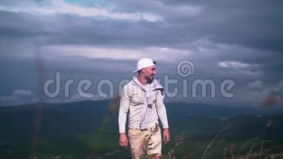 年轻英俊的男人走在山里视频的预览图