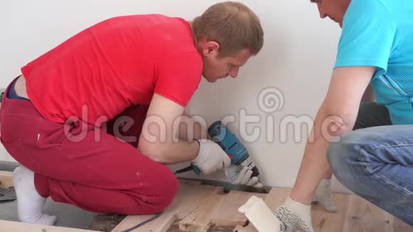 房子里的木工两个职业男子坐松木地板视频的预览图