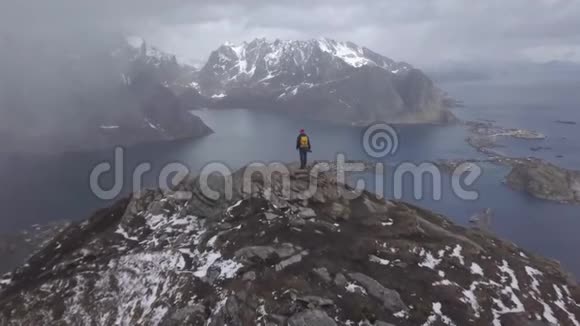 自然摄影师带着相机拍摄站在山顶美丽的自然挪威视频的预览图