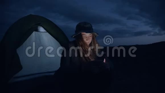 冒险旅行女子卷轴电话在营地视频的预览图