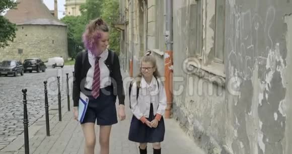 两个正在上学的女孩穿着校服带着背包说话的孩子视频的预览图