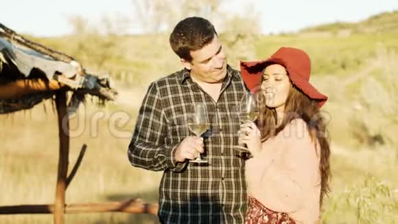 一对夫妇在温暖的阳光下品尝白葡萄酒视频的预览图