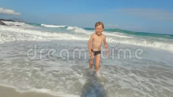 一个小男孩在热带海滩玩的慢镜头夏季概念视频的预览图