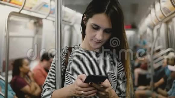 一位严肃自信压力大的女商人在地铁列车上使用智能手机移动办公应用程序打字视频的预览图