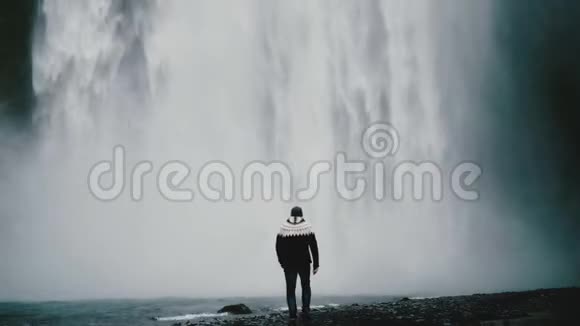 年轻的旅行者走在冰岛强大的Gljufrabui瀑布附近举起双手感到快乐视频的预览图