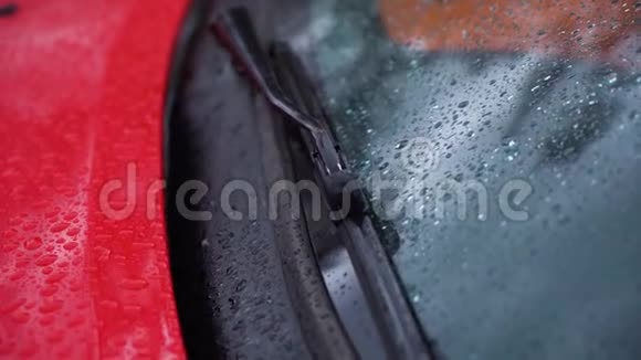 关闭红色跑车雨刷在雨天的镜头视频的预览图