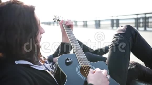 一个留着长发的年轻人弹吉他唱歌视频的预览图