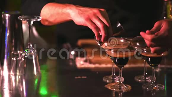 将迷人英俊的亚洲男调酒师用黑色正式套装和红色领带混合做成鸡尾酒作为艺人视频的预览图