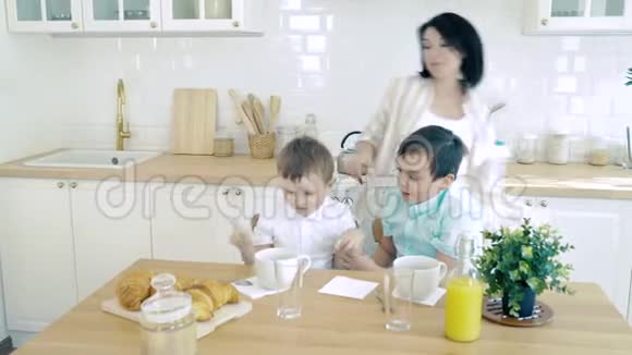厨房里的幸福家庭妈妈为她的儿子做早餐视频的预览图