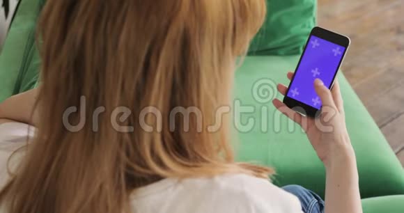 女士正在使用手机与色度键紫色垂直屏幕手机和手特写视频的预览图