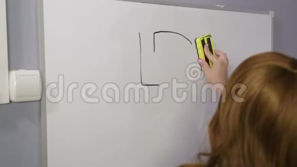 一个女人背着她站着擦去白板上画好的货币标志视频的预览图