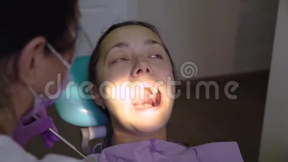 在牙科诊所治疗过程中在牙科医生的中年妇女口腔医生与病人的工作视频的预览图