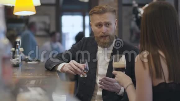 布鲁内特女士和自信的金发男子坐在酒吧柜台关门夜间生活方式的概念可爱视频的预览图