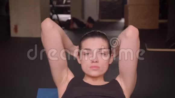 年轻有魅力的运动员女性在室内健身房锻炼看镜头的特写镜头视频的预览图