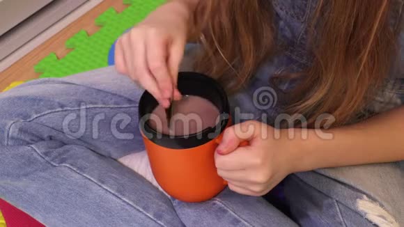 可爱的小女孩拿着一杯热可可饮料视频的预览图
