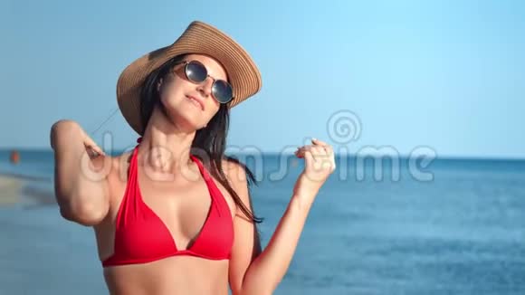 性感的女游客穿着泳装度假时在蓝海背景下享受日光浴视频的预览图