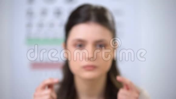 视力极差的女人用手指挤压眼睛试图集中注意力视频的预览图